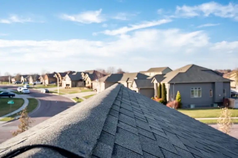 View down the top of an asphalt shingle roof with ridge cap